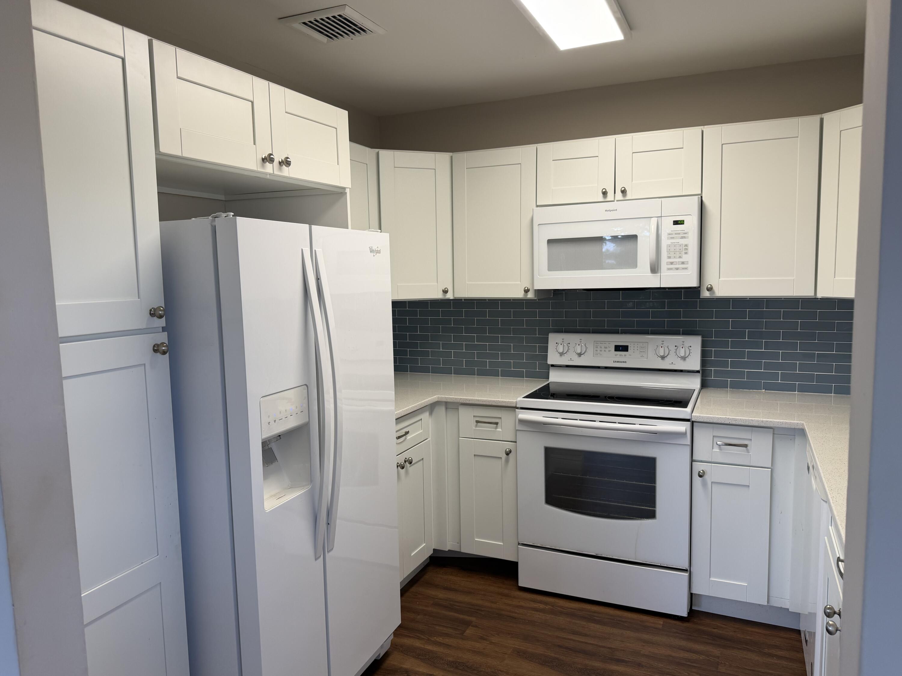 340 Orange Tree Drive, Unit 1 Atlantis, FL 33462 - Photo 12 of 23 a kitchen with cabinets and steel stainless steel appliances