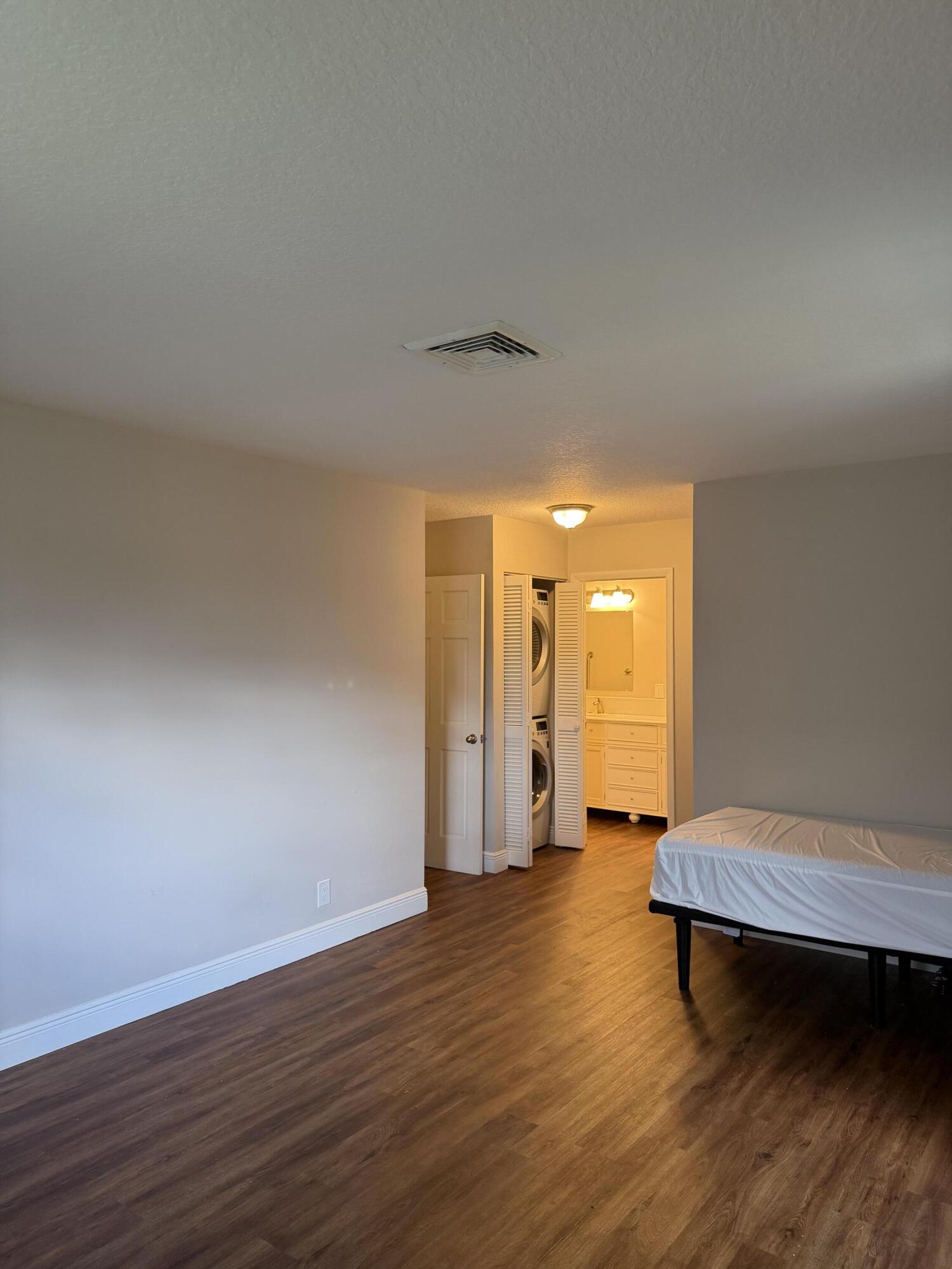 340 Orange Tree Drive, Unit 1 Atlantis, FL 33462 - Photo 15 of 23 a view of a room with wooden floor and a window