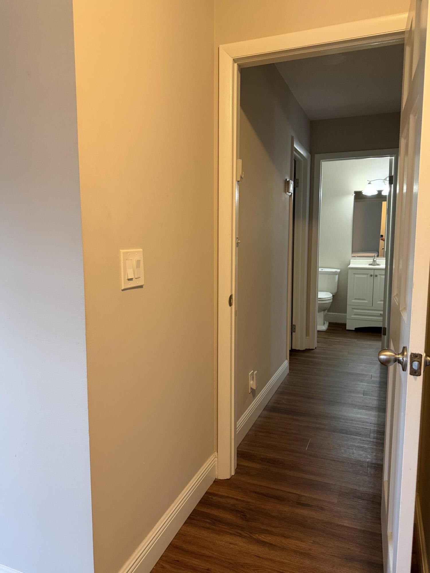 340 Orange Tree Drive, Unit 1 Atlantis, FL 33462 - Photo 19 of 23 a view of a hallway with wooden floor