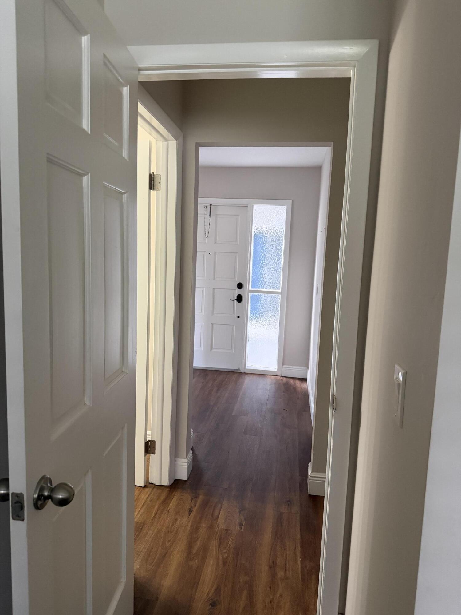 340 Orange Tree Drive, Unit 1 Atlantis, FL 33462 - Photo 20 of 23 a view of a hallway with wooden floor