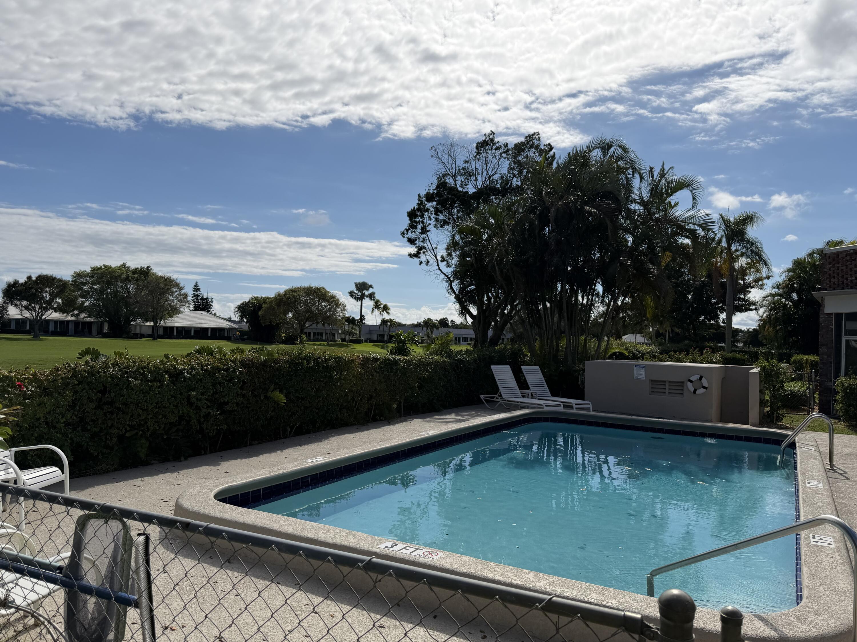 340 Orange Tree Drive, Unit 1 Atlantis, FL 33462 - Photo 22 of 23 a view of a lake with a yard