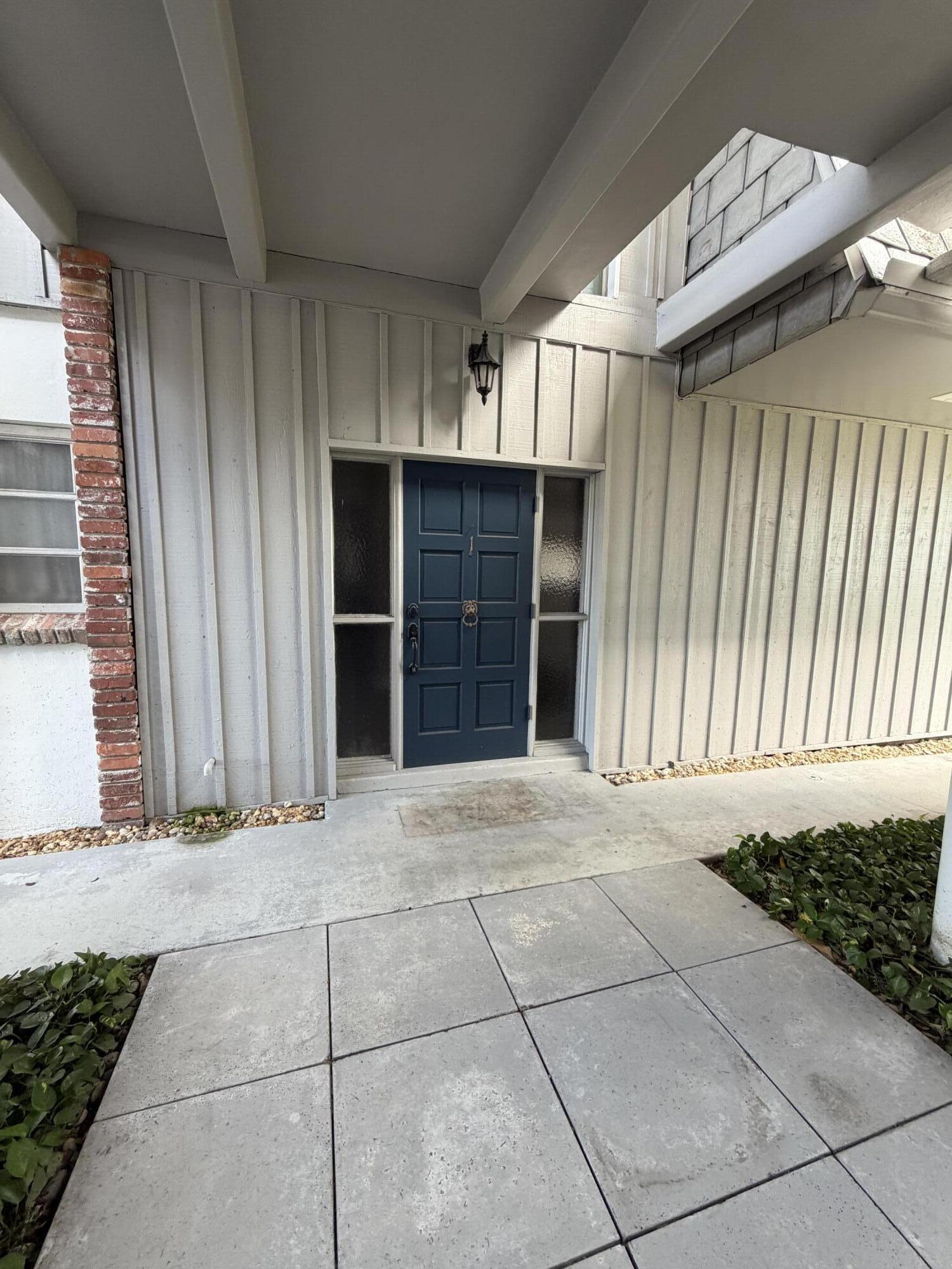 340 Orange Tree Drive, Unit 1 Atlantis, FL 33462 - Photo 3 of 23 a view of an entrance of the house