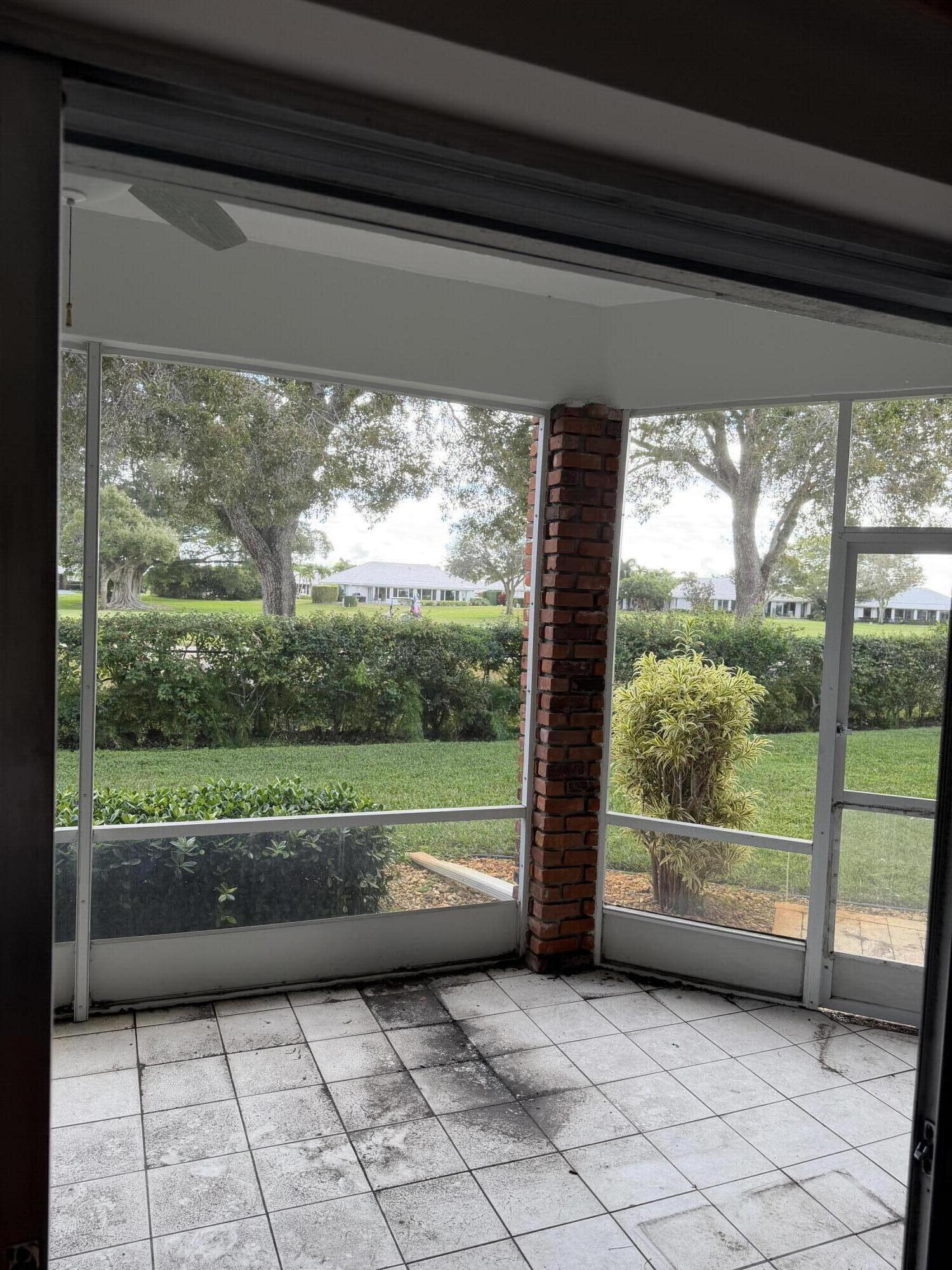 340 Orange Tree Drive, Unit 1 Atlantis, FL 33462 - Photo 6 of 23 a view of a room with a large window and a table