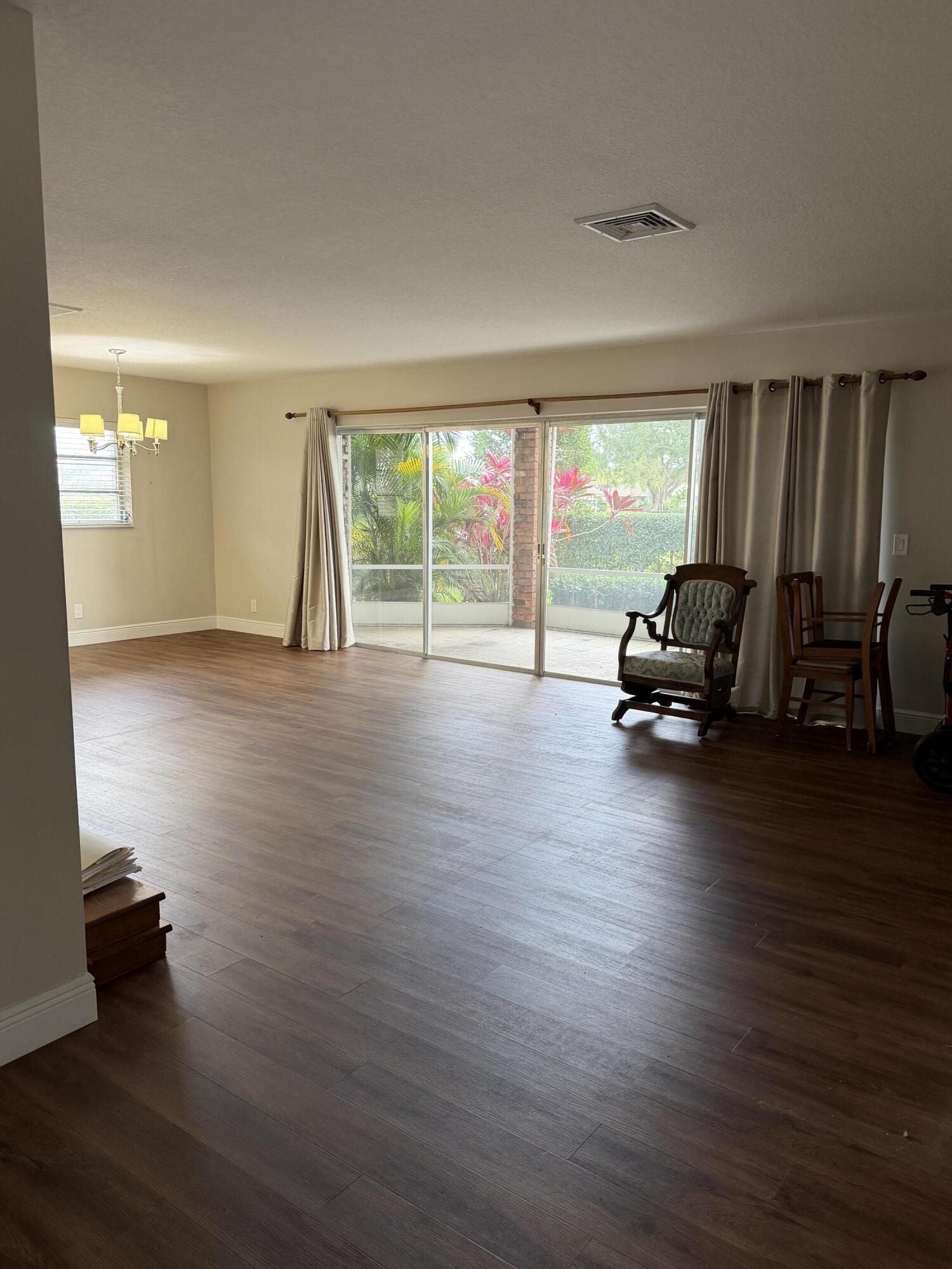 340 Orange Tree Drive, Unit 1 Atlantis, FL 33462 - Photo 8 of 23 a living room with furniture and a large window