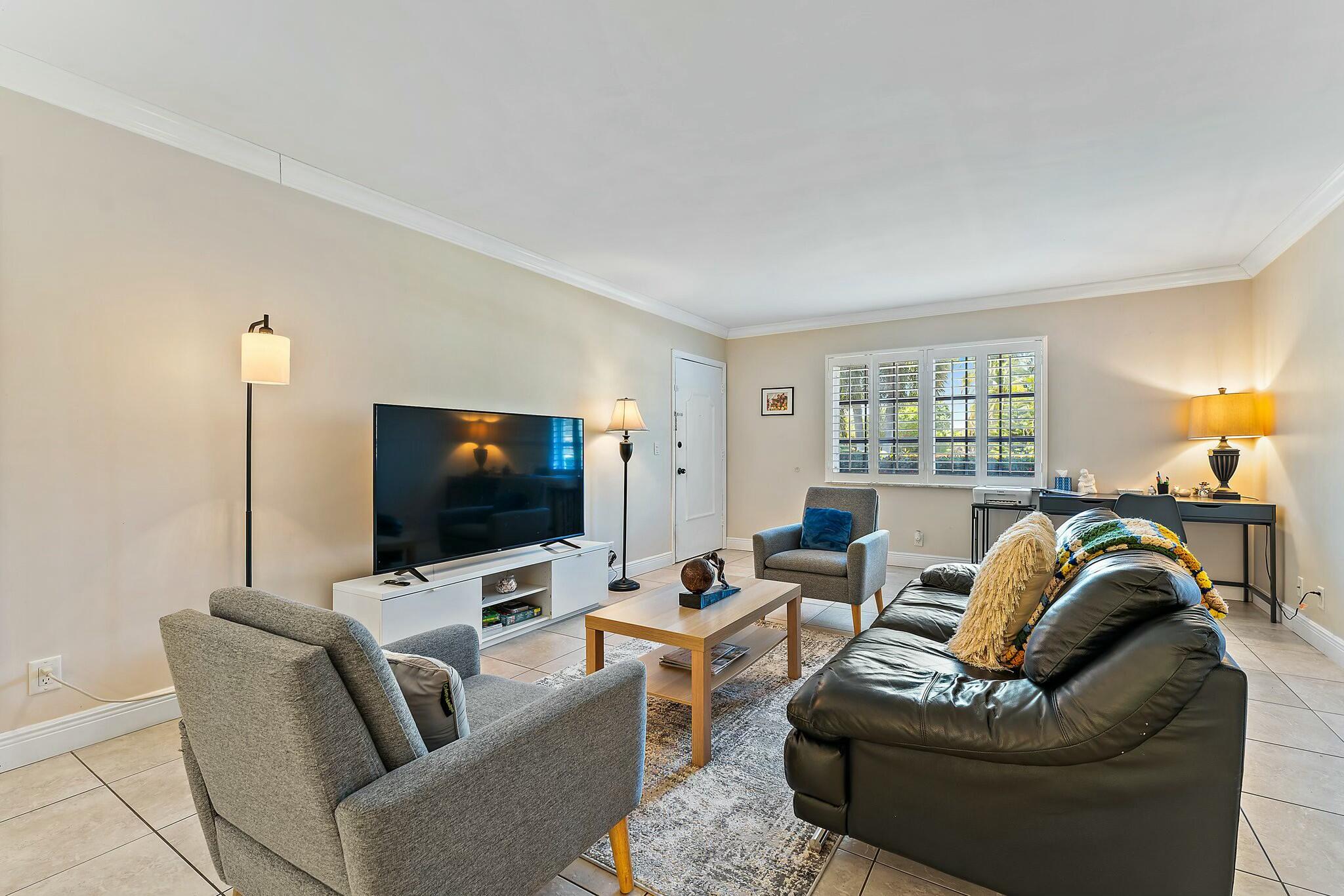 3036 Park Avenue Riviera Beach, FL 33404 - Photo 3 of 22 a living room with furniture and a flat screen tv
