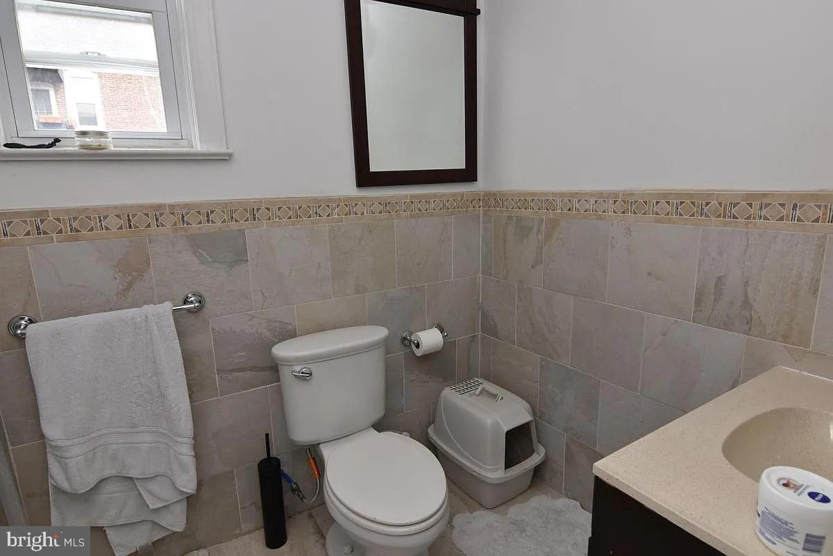 211 South 45th Street Philadelphia, PA 19104 - Photo 3 of 6 a white toilet sitting next to a bathroom sink