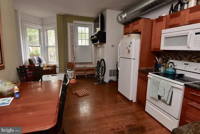 a kitchen with sink refrigerator and window