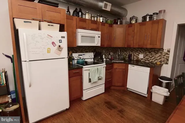 a white refrigerator freezer sitting inside of a kitchen