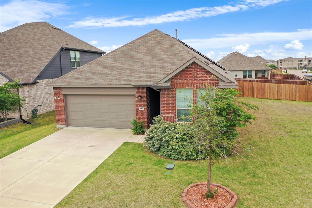 a front view of a house with a yard and potted plants