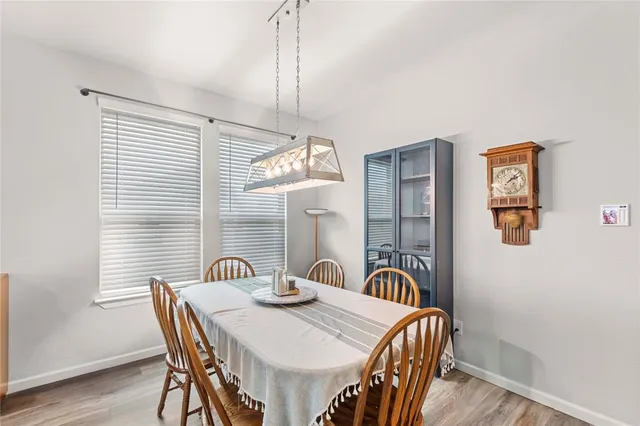 a view of a dining room with furniture and chandelier
