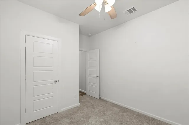 an empty room with a ceiling fan