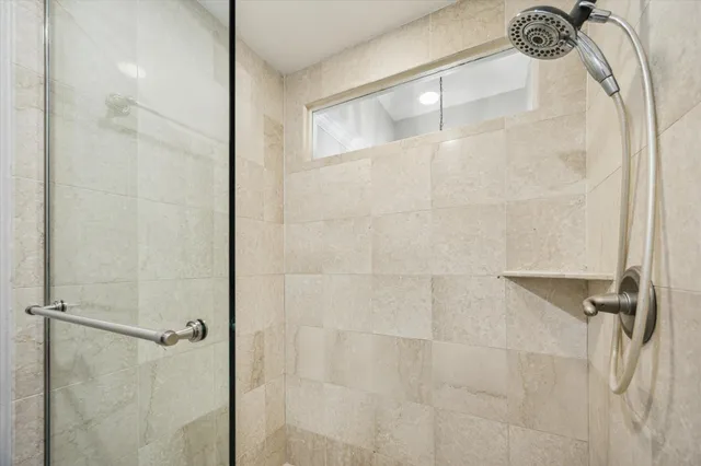 a view of a backyard with plants and large trees