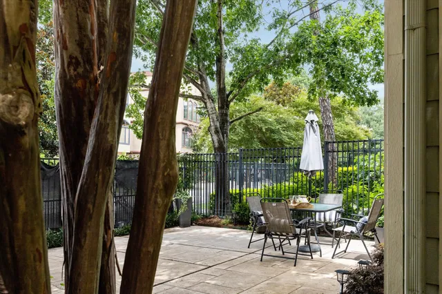 a patio with couple of furniture and garden