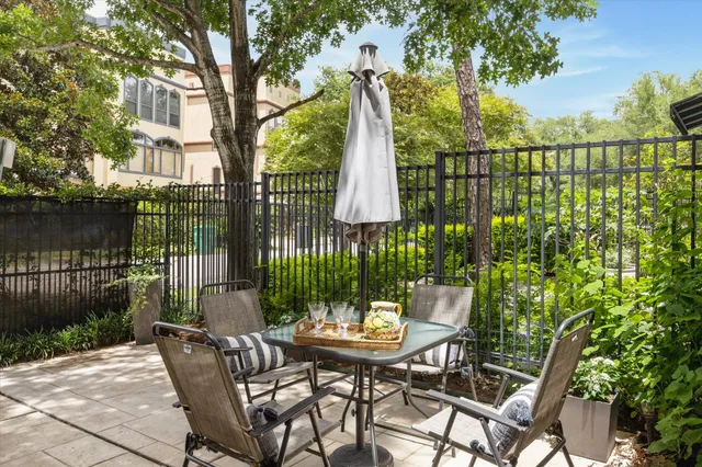 a view of a patio with a table chairs and a garden