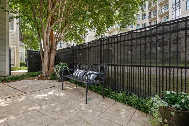 a view of a backyard with a large window and wooden fence