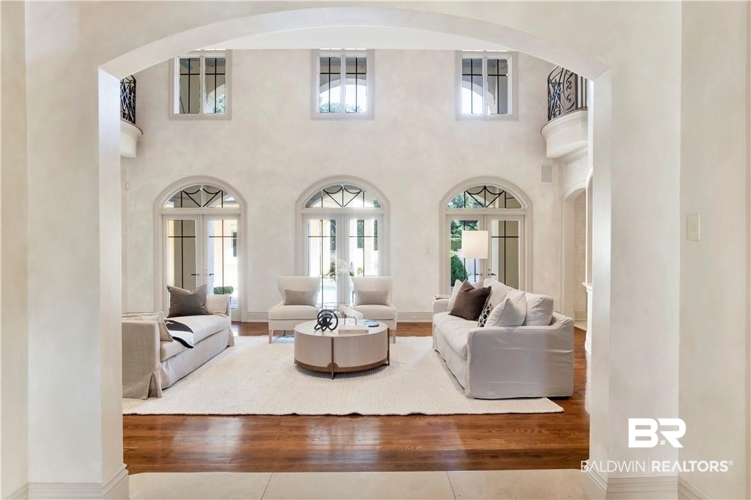 4 Chancery Court Mobile, AL 36608 - Photo 12 of 54 Living room featuring french doors, a towering ceiling, and hardwood / wood-style floors