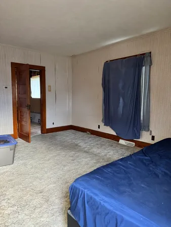 an empty room with wooden floor and closet