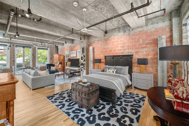 a bedroom with furniture and wooden floor