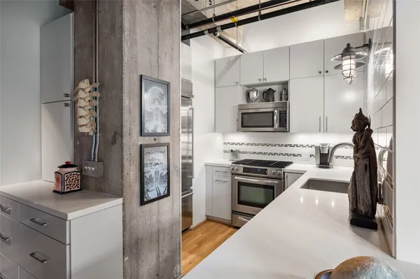 a kitchen with stainless steel appliances granite countertop a refrigerator and a stove top oven