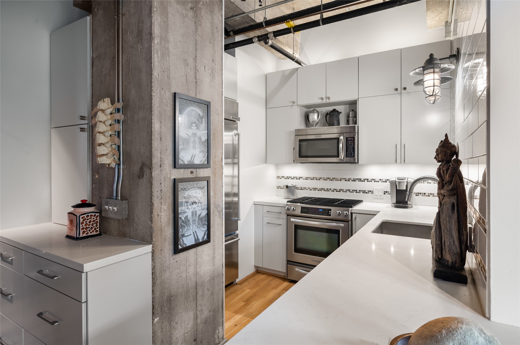 204 Travis Street, Unit 2C Houston, TX 77002 - Photo 13 of 28 a kitchen with stainless steel appliances granite countertop a refrigerator and a stove top oven