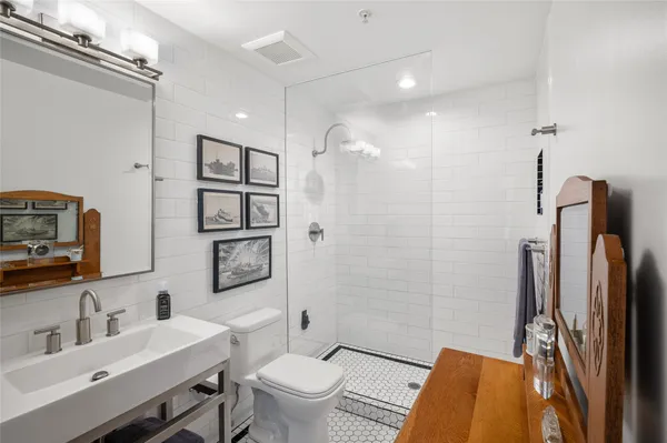 a bathroom with a sink toilet and shower