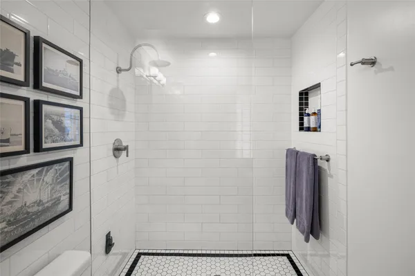 a bathroom with a shower and a mirror