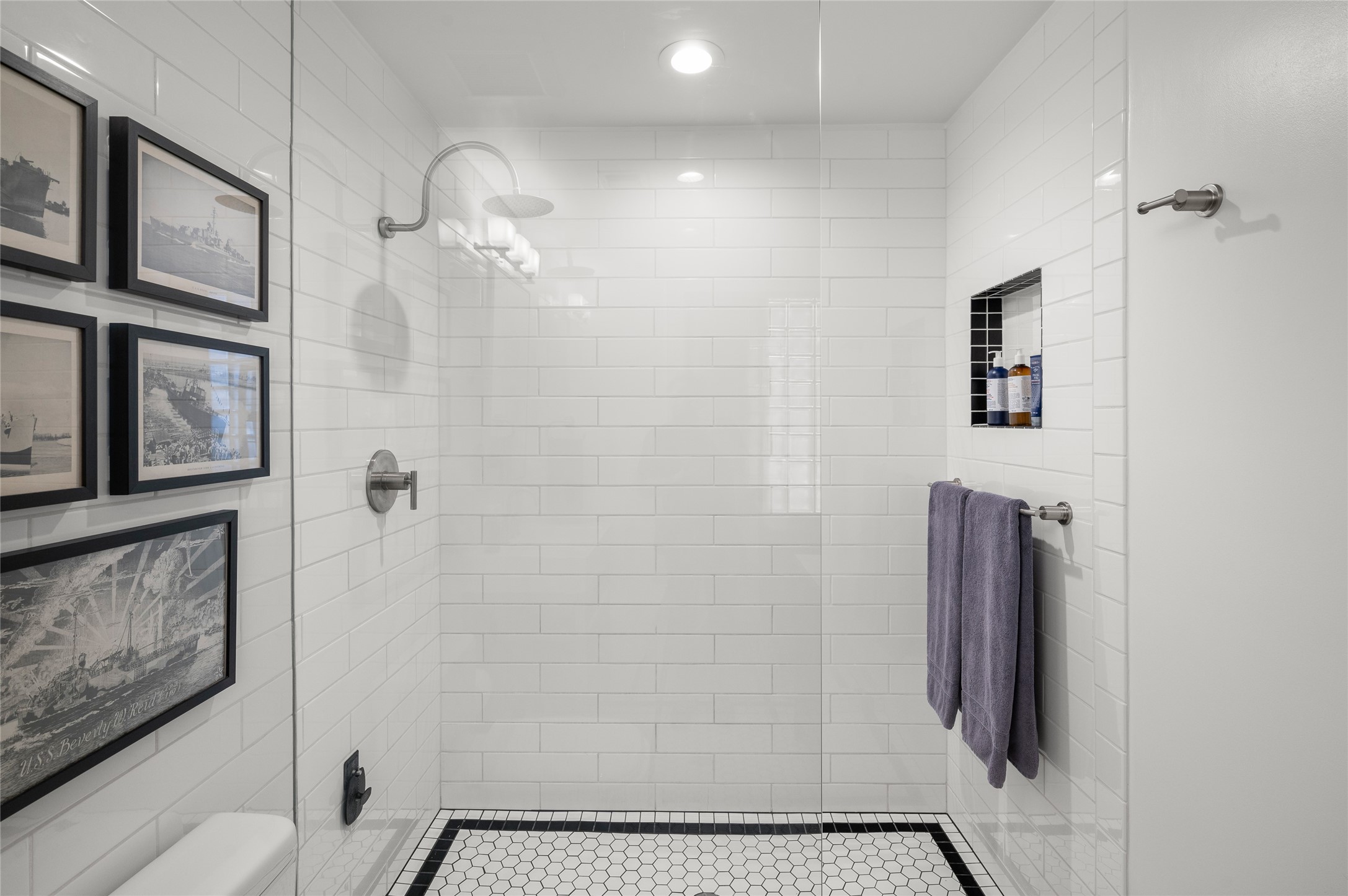 204 Travis Street, Unit 2C Houston, TX 77002 - Photo 16 of 28 a bathroom with a shower and a mirror