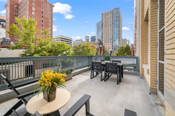 a view of balcony with chairs and a potted plant
