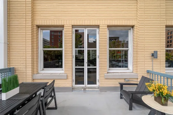 a view of a house with a deck and furniture