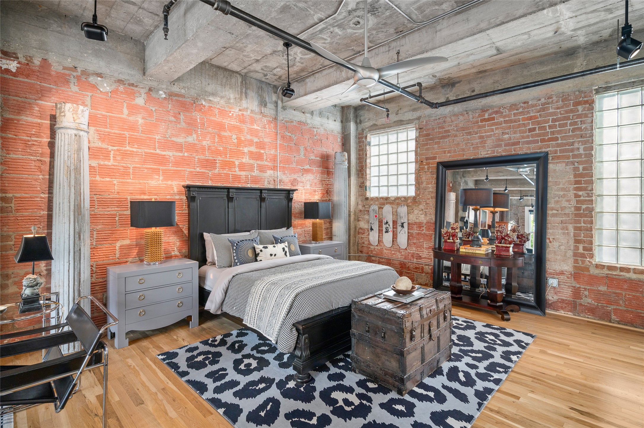 204 Travis Street, Unit 2C Houston, TX 77002 - Photo 3 of 28 a bedroom with a bed and wooden floor