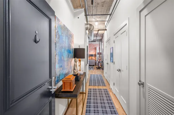 a view of a hallway with wooden floor and staircase