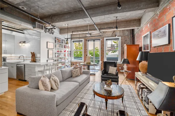 a living room with furniture and a chandelier