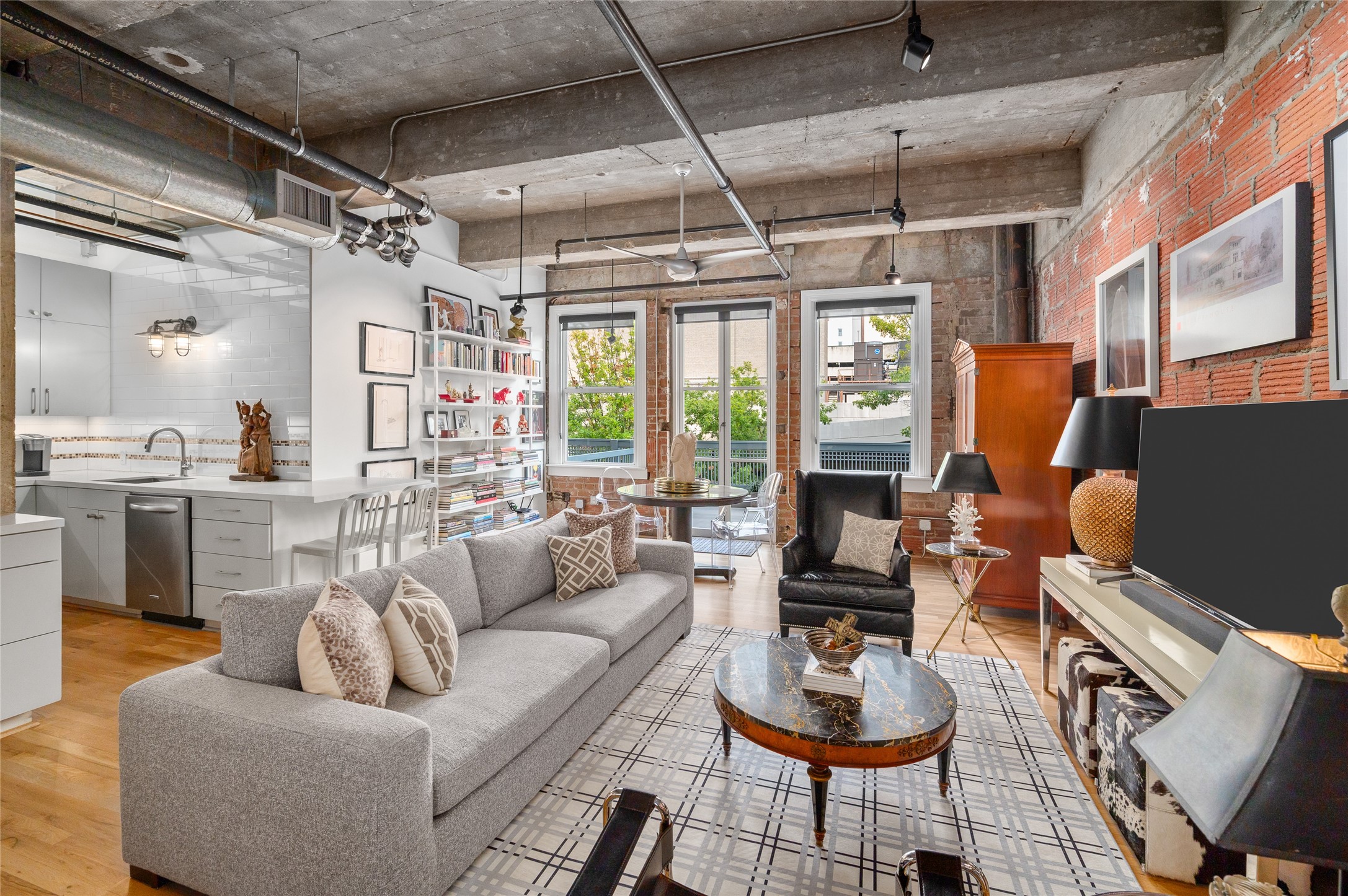 204 Travis Street, Unit 2C Houston, TX 77002 - Photo 7 of 28 a living room with furniture and a chandelier