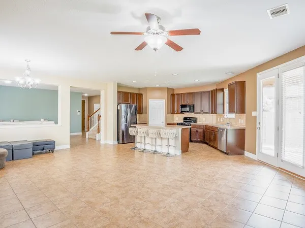 a view of a kitchen with furniture and a ceiling fan