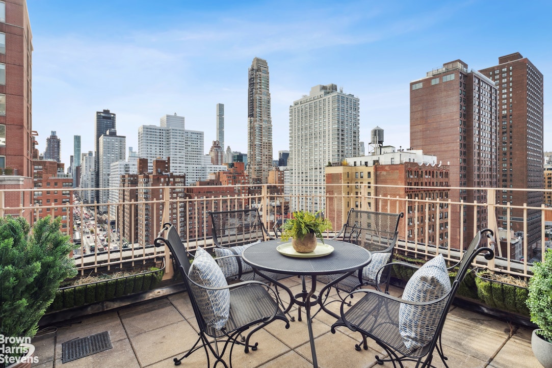 305 East 72nd Street, Unit PHC Manhattan, NY 10021 - Photo 4 of 9 a view of a balcony with two chairs and a potted plant