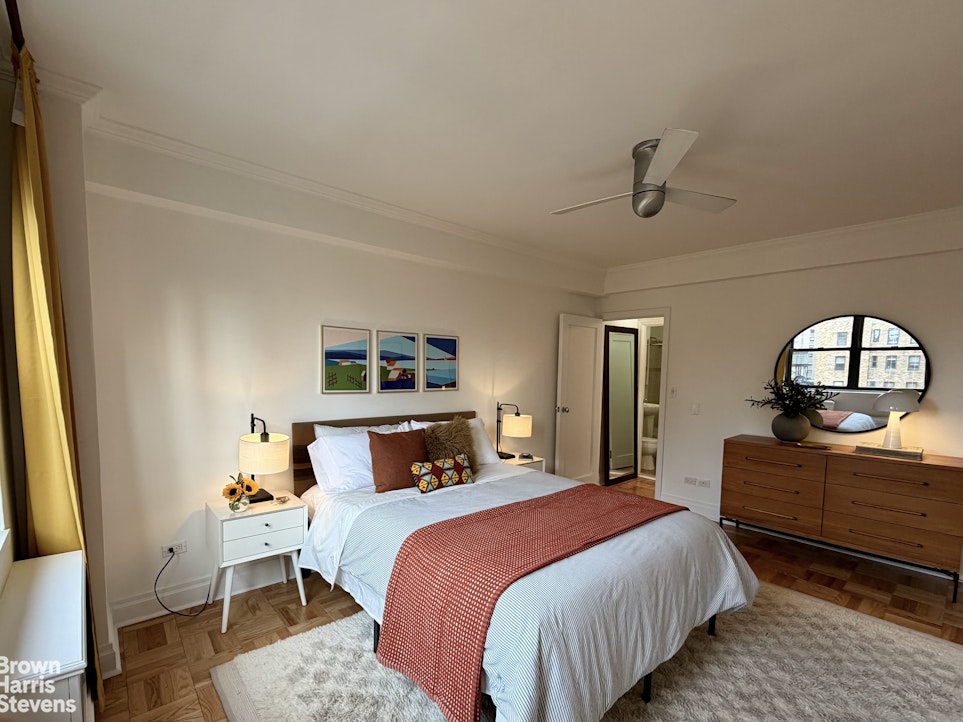 305 East 72nd Street, Unit PHC Manhattan, NY 10021 - Photo 7 of 9 a bedroom with a bed and a dresser with mirror