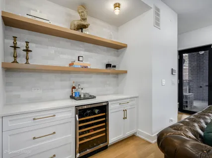 a kitchen with a cabinets and chandelier
