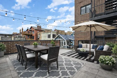 a view of a patio with table and chairs and potted plants
