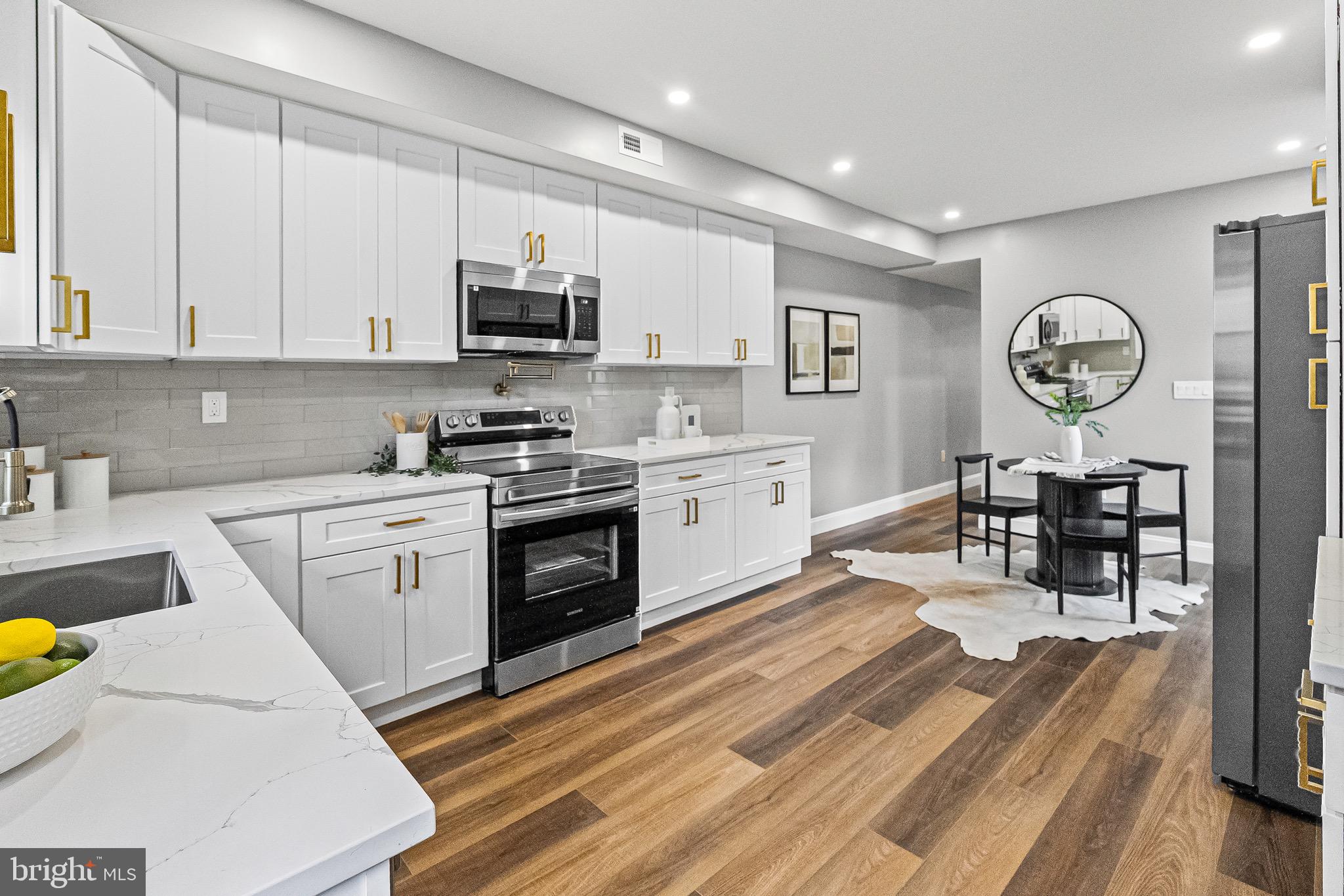 1600 Federal Street Baltimore, MD 21213 - Photo 11 of 31 a kitchen with a stove top oven sink and cabinets