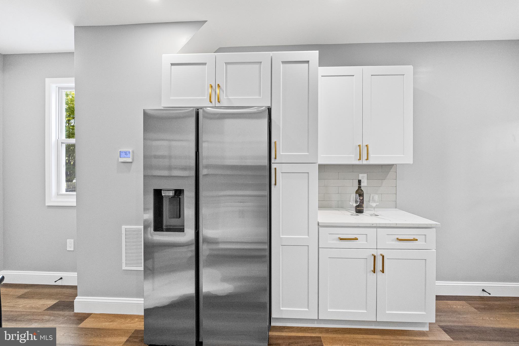 1600 Federal Street Baltimore, MD 21213 - Photo 12 of 31 a kitchen with stainless steel appliances kitchen island a refrigerator sink and cabinets