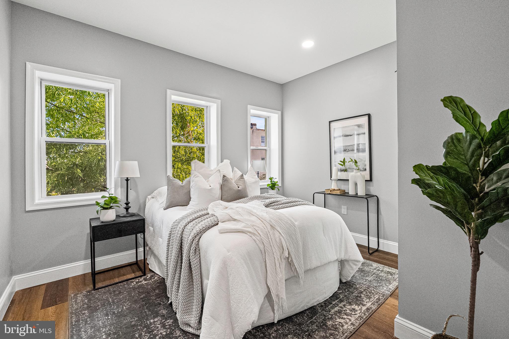 1600 Federal Street Baltimore, MD 21213 - Photo 13 of 31 a bedroom with a bed and a potted plant