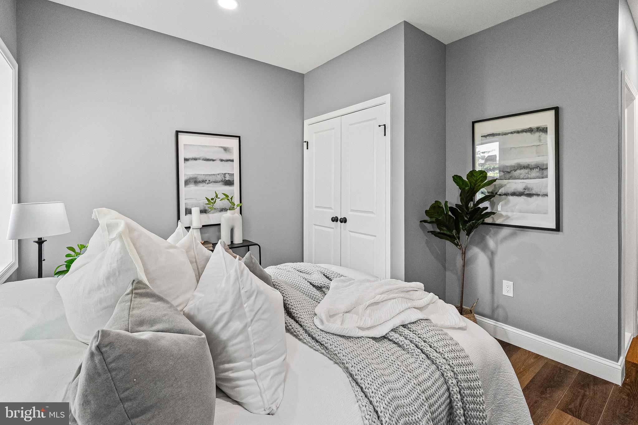 1600 Federal Street Baltimore, MD 21213 - Photo 14 of 31 a bedroom with a bed and a potted plant