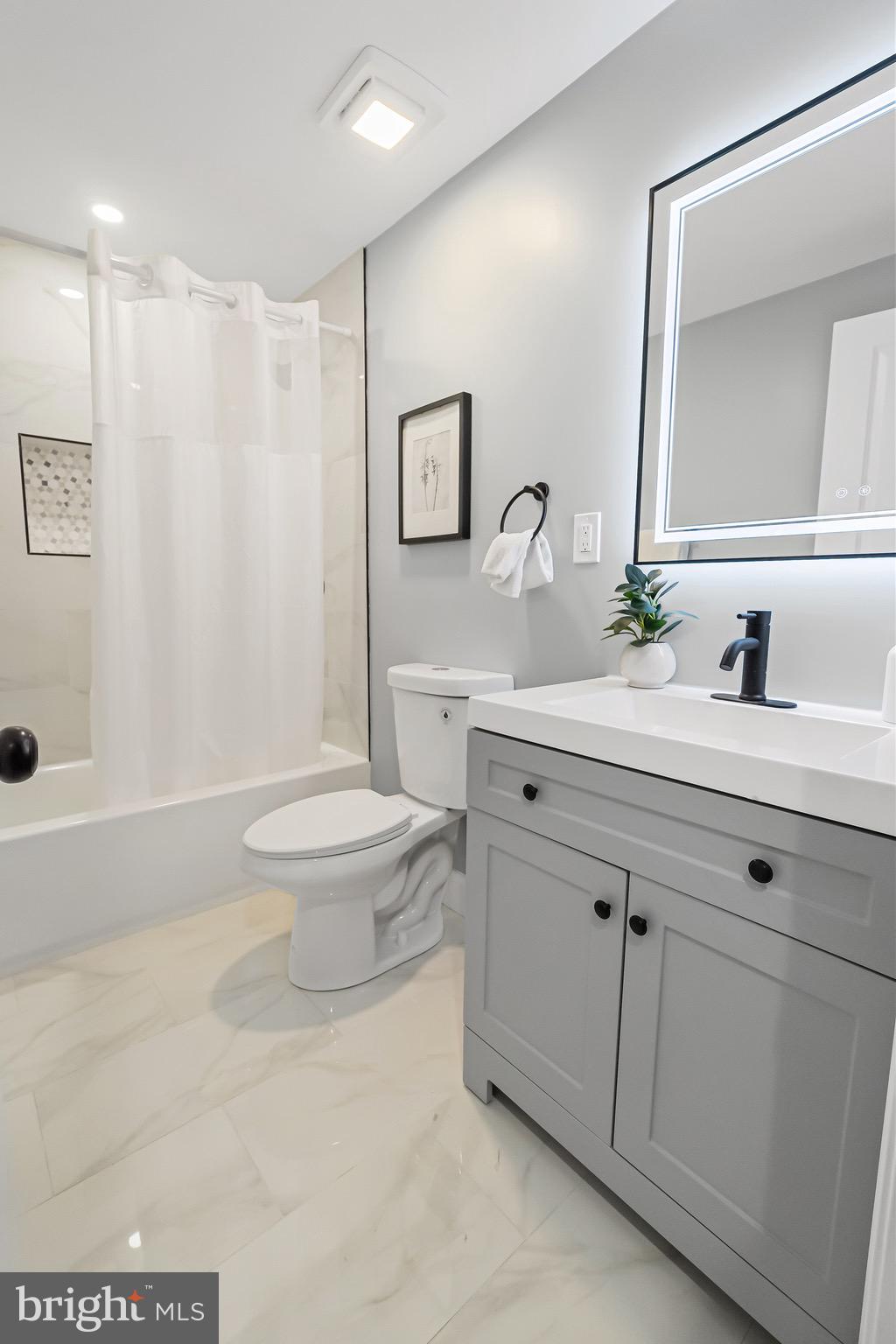 1600 Federal Street Baltimore, MD 21213 - Photo 20 of 31 a bathroom with a double vanity sink toilet and a mirror