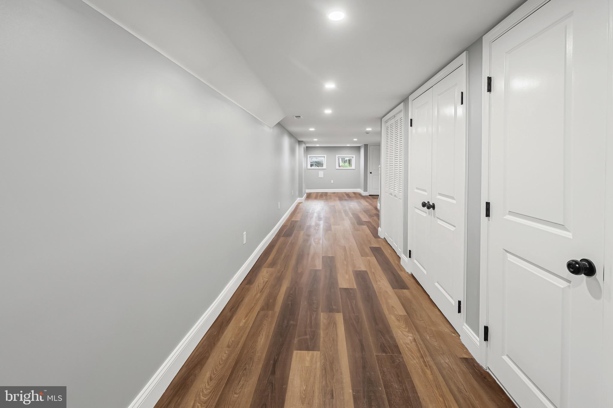 1600 Federal Street Baltimore, MD 21213 - Photo 29 of 31 a view of a hallway with wooden floor and a bathroom