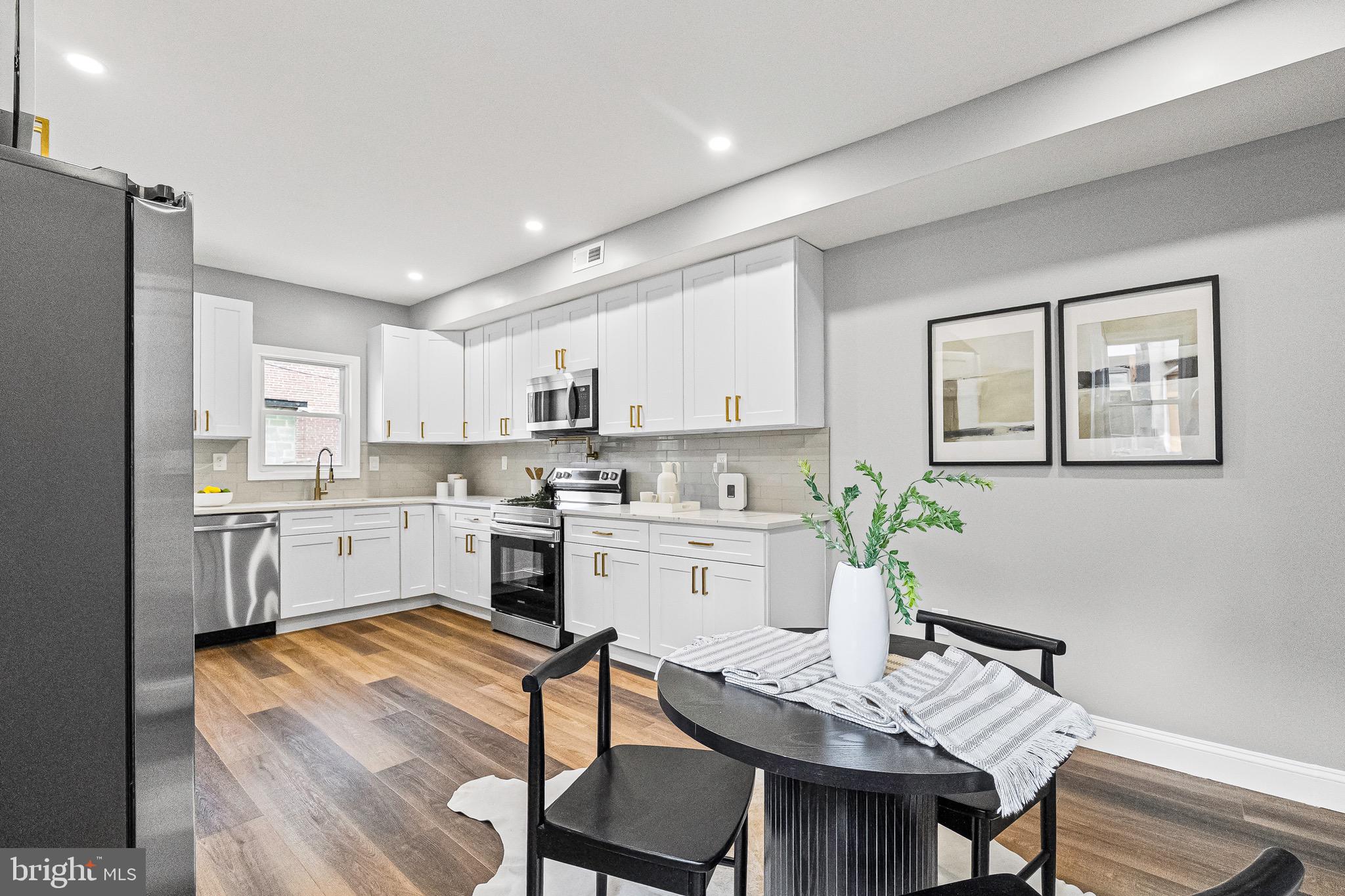 1600 Federal Street Baltimore, MD 21213 - Photo 10 of 31 a kitchen with white cabinets and white appliances