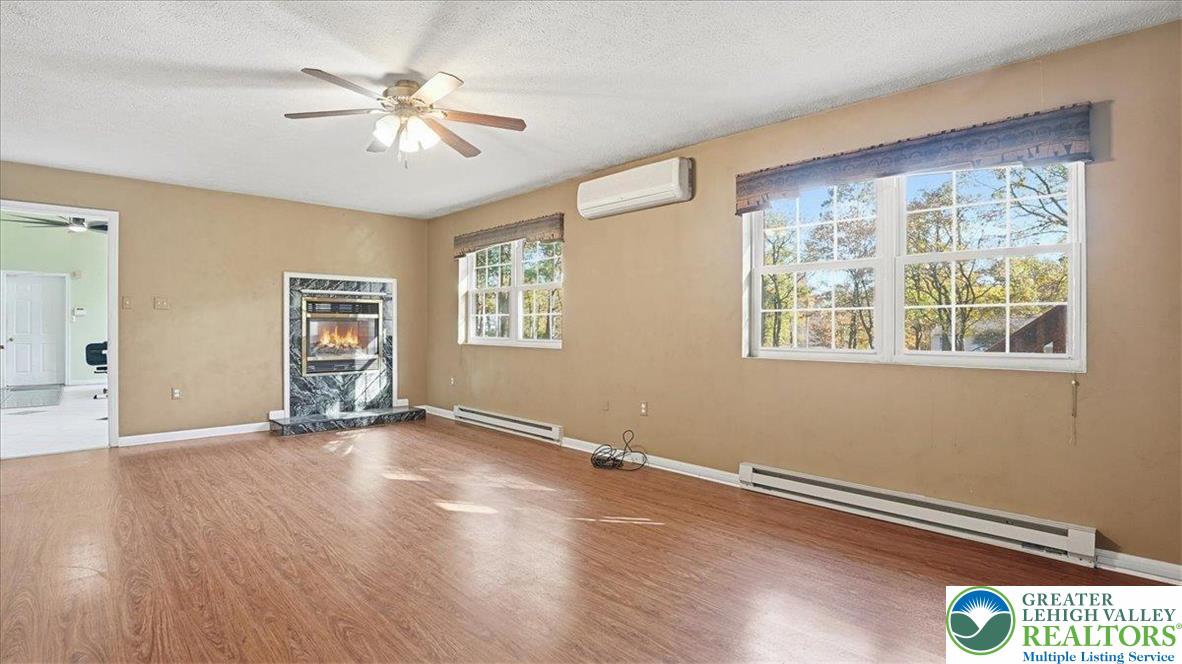349 Bumble Bee Pass Cresco, PA 18326 - Photo 16 of 92 a view of an empty room with a window and wooden floor