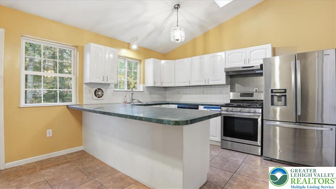 349 Bumble Bee Pass Cresco, PA 18326 - Photo 22 of 92 a kitchen with granite countertop a sink stainless steel appliances and window