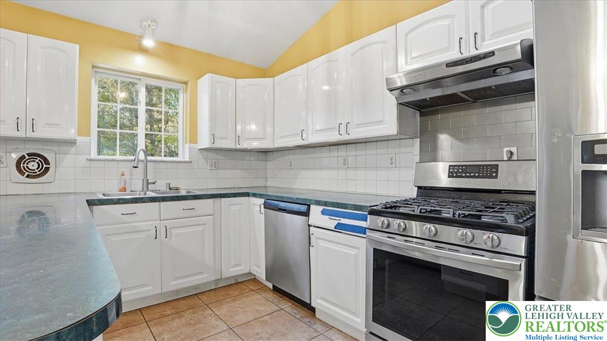 349 Bumble Bee Pass Cresco, PA 18326 - Photo 23 of 92 a kitchen with cabinets appliances a sink and a window