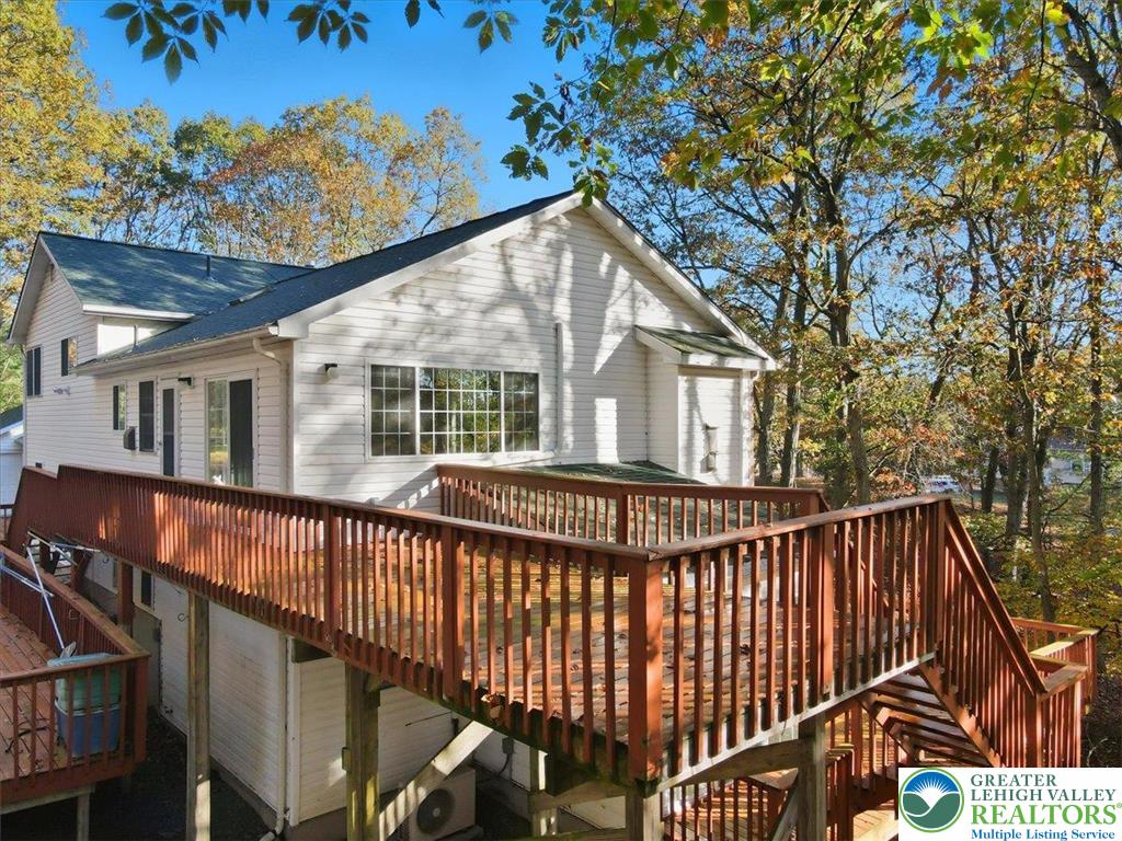 349 Bumble Bee Pass Cresco, PA 18326 - Photo 71 of 92 a view of house with a deck and a backyard