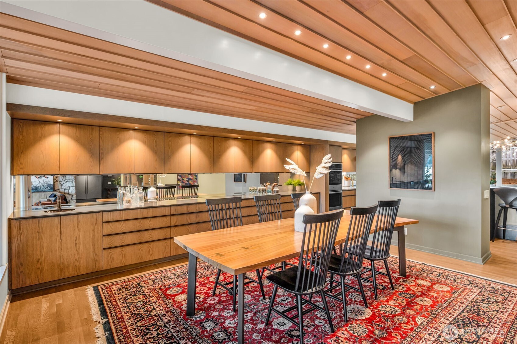 6437 Hampton Road South Seattle, WA 98118 - Photo 11 of 39 a view of a dining room with furniture a chandelier and wooden floor